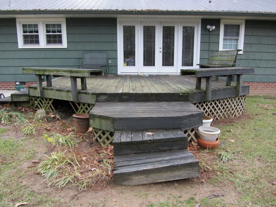 Worn old deck and steps behind a house